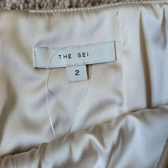 High waisted skort in soft beige leather has a hidden short under a high-low ski - Picture 7 of 7